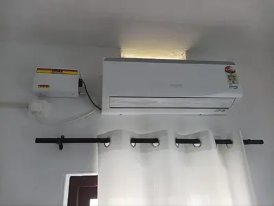 a bathroom with a microwave and a curtain at BHASURI VILLA Attappady in Varagampadi