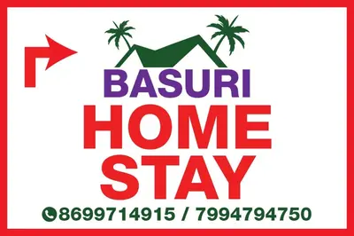 a sign for a beach home stay with a hammock and palm trees at BHASURI VILLA Attappady in Varagampadi
