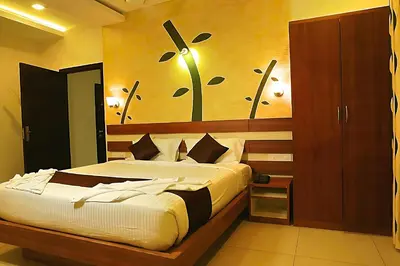 a bedroom with a bed with a flower painting on the wall at Mist Wayanad in Wayanad