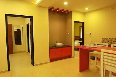 a bathroom with a counter and a sink in a room at Mist Wayanad in Wayanad