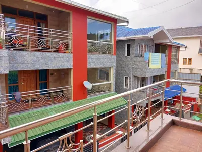 a view of a building with a balcony at Serenity inn - Rose Garden in Ooty
