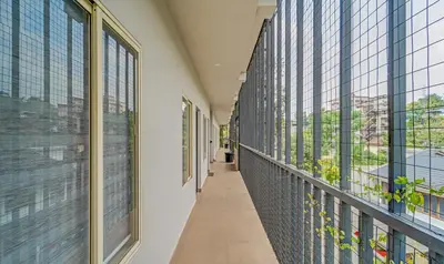 an empty corridor in a building with windows at Treebo Regalia Inn Wayanad With Swimming Pool in Kalpetta