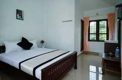 a bedroom with a large bed and a window at Mountain View cottage Mankulam in Munnar