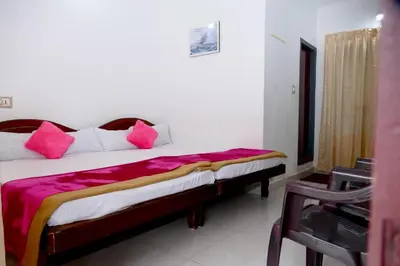 a bedroom with a bed with pink pillows on it at Mountain View cottage Mankulam in Munnar