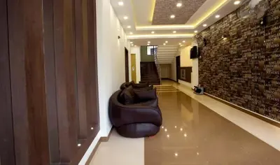 a room with a couch sitting in the middle of a hallway at Rotano Glitz Inn - Glitz Inn Calicut in Kozhikode