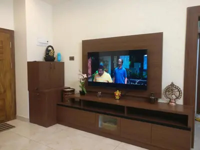 a living room with a flat screen tv at SindooRa in Mysore