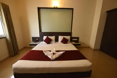 a hotel room with a bed with a flower on it at Hotel LandmarK Coimbatore in Coimbatore