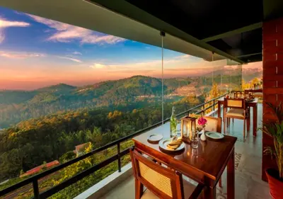 a dining room with a view of the mountains at Sleeping Beauty by Nature Resorts and Stays in Coonoor