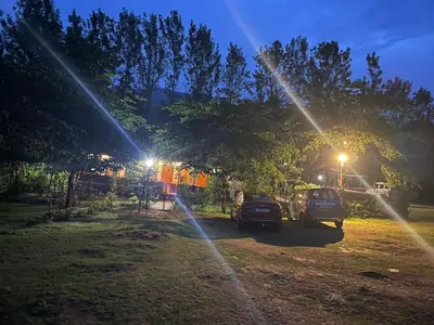 a group of cars parked in a park at night at Wild Valley Club in Masinagudi