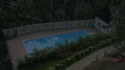 an overhead view of a swimming pool in a backyard at Mountain Vibes Resort Wayanad in Wayanad