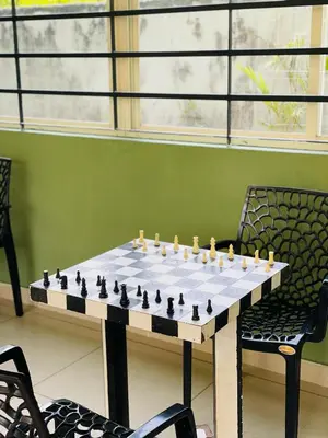 a chess board on a table with two chairs at Caravan holiday homes Vythiri in Vythiri