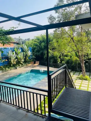 a view from the balcony of a house with a swimming pool at Caravan holiday homes Vythiri in Vythiri