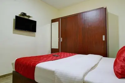 a bedroom with a large bed with a wooden door at Pinehill Suites in Ooty