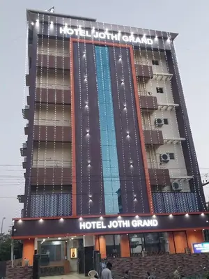 a hotel with a sign on the front of it at Hotel Jothi Grand in Coimbatore