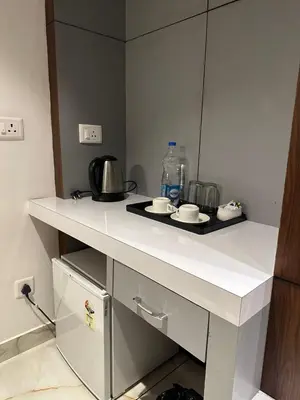 a kitchen with a white counter top with a sink at Hotel Vrindavan in Wayanad