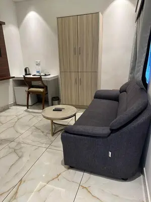 a living room with a couch and a table at Hotel Vrindavan in Wayanad