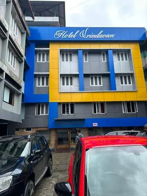 two cars parked in front of a building at Hotel Vrindavan in Wayanad