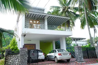 a car parked in front of a house at Oxygen Home Stay in Agali