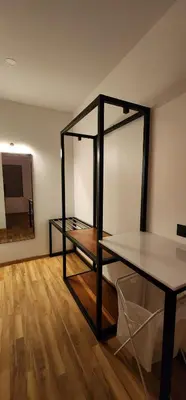 a room with a glass shelf and a mirror at Bendheka - Cliff Front Cottages Coorg in Gonikoppal