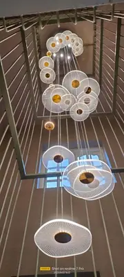a row of white dishes hanging from a ceiling at INN THE MOUNTAIN'S in Kodaikānāl