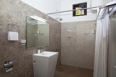 a bathroom with a toilet and a sink and a shower at StayVista at Ivory Hill Madikeri including breakfast 3 Bhk Villa in Madikeri