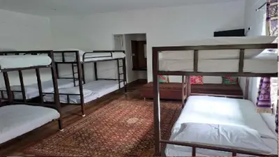 a group of bunk beds in a room at Blossom Inn in Coonoor